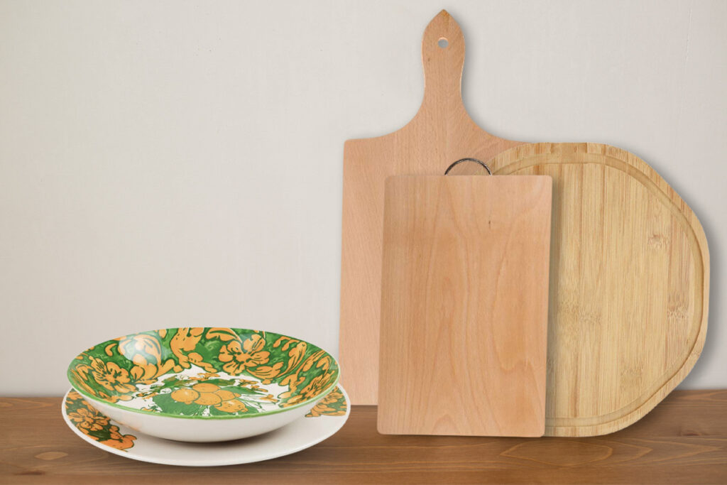 Composizione con accessori da cucina in stile rustico: taglieri in legno e piatti in ceramica